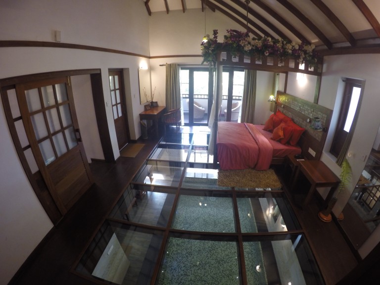 The honeymoon suite at Vythiri Resort, Wayanad with a glass floor and a private pool
